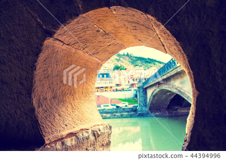 View of the city through the arch of the bridge View of the city through the arch of the bridge 44394996