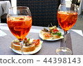 Italian aperitif with some apetizers  44398143