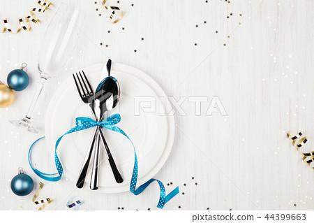 Christmas table setting with blue and golden decorations. Christmas table setting with blue and golden decorations. 44399663