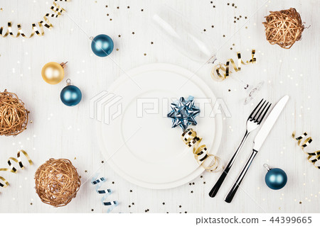 Christmas table setting with blue and golden decorations. Christmas table setting with blue and golden decorations. 44399665