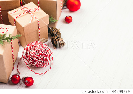 Christmas gift boxes collection with evergreenes and red Christmas balls. 44399759