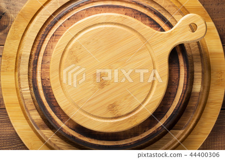 pizza or bread cutting board at wooden table pizza or bread cutting board at wooden table 44400306