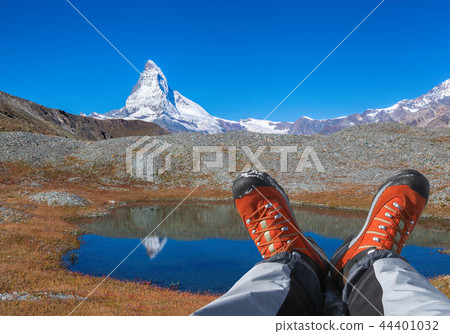 Matterhorn peak with hiking boots in Swiss Alps. Matterhorn peak with hiking boots in Swiss Alps. 44401032