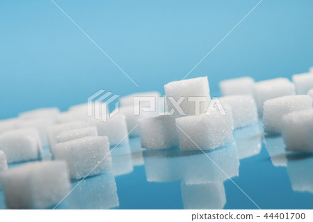 Sugar cubes on an on light blue background Sugar cubes on an on light blue background 44401700