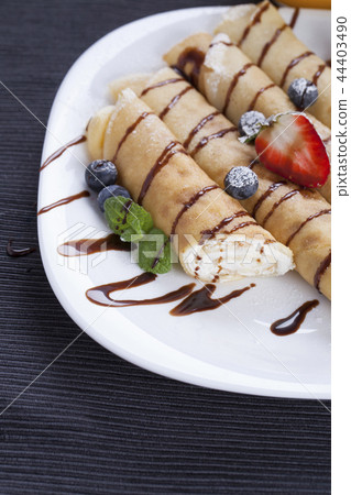 Delicious sweet rolled pancakes 44403490