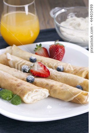 Delicious sweet rolled pancakes  44403499