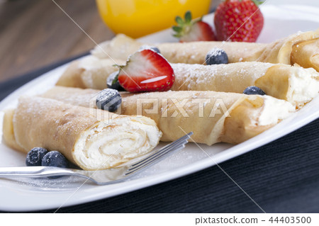 Delicious sweet rolled pancakes  44403500