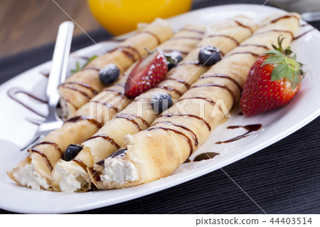 Delicious sweet rolled pancakes  44403514
