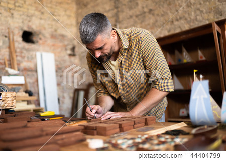 Wood carpenter at work in his workshop 44404799