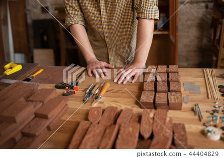 Close-up view of a wood carpenter's hands Close-up view of a wood carpenter's hands 44404829