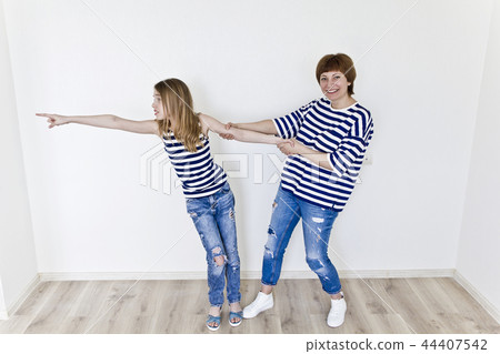 Beautiful mother and daughter on white Beautiful mother and daughter on white 44407542