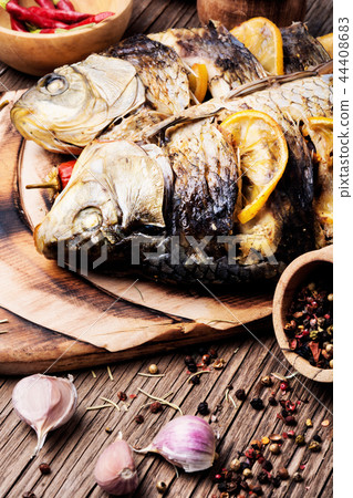 Fish baked with vegetable garnish Fish baked with vegetable garnish 44408683