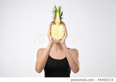 Young caucasian girl holding Pineapple. Young caucasian girl holding Pineapple. 44409219