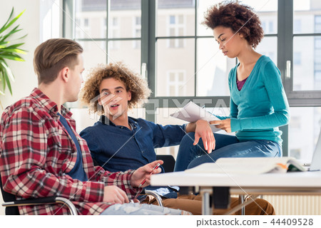 Young student writing during brainstorming for a group assignment 44409528