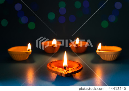 Happy Diwali - Clay Diya lamps lit during Dipavali 44412240