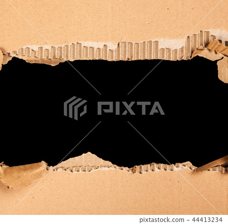Cardboard with a hole - black background Cardboard with a hole - black background 44413234
