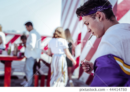 Close up of sad man that smoking cigarette Close up of sad man that smoking cigarette 44414780