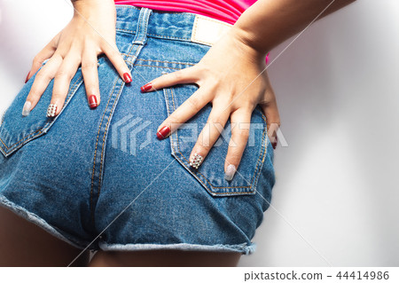 Women are showing red nails. 44414986