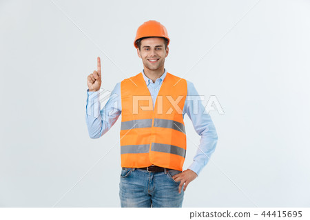 Happy young construction workers in hard hats on a white background. Happy young construction workers in hard hats on a white background. 44415695