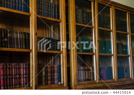 Old books in wooden row library Old books in wooden row library 44415914