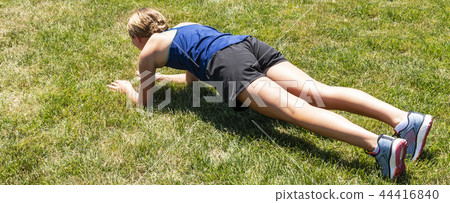 Front plank on grass from the back side Front plank on grass from the back side 44416840