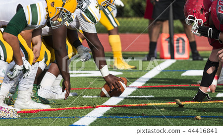Two football teams lined up over the ball 44416841