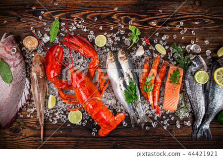 Fresh tasty seafood served on old wooden table. 44421921