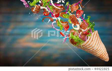 Kebab sandwich with flying ingredients. 44421925