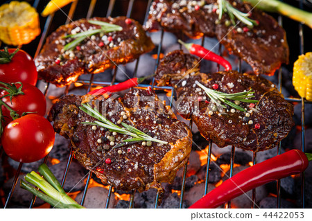 Barbecue grill with beef steaks, close-up. Barbecue grill with beef steaks, close-up. 44422053