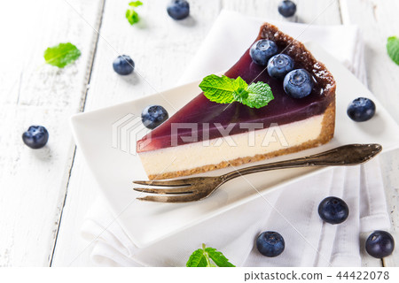 Delicious cheesecake with blueberries on wooden table. Delicious cheesecake with blueberries on wooden table. 44422078