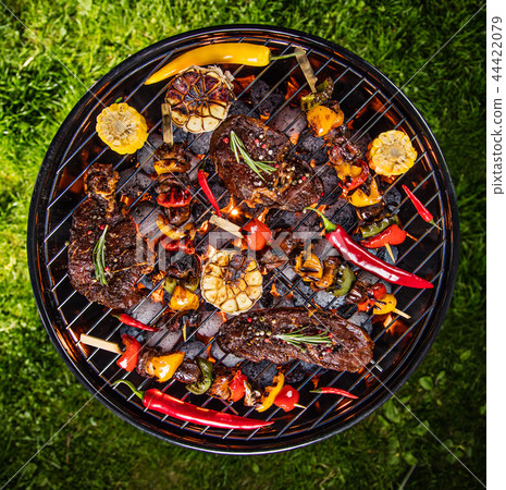 Barbecue grill with beef steaks, close-up. 44422079