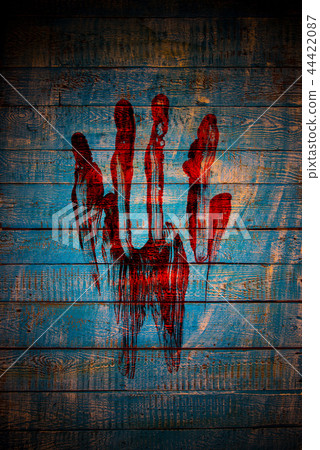 Bloody fingerprint on old wooden background. 44422087