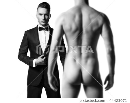 Man in suit in front of nude man 44423071