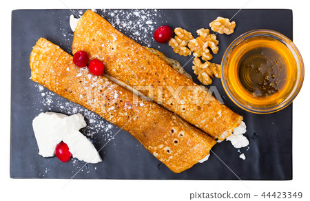 Top view of Bulgarian crepes Palatschinke on black board Top view of Bulgarian crepes Palatschinke on black board 44423349