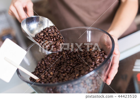 Photo of dark corns of coffee in glass container Photo of dark corns of coffee in glass container 44423510