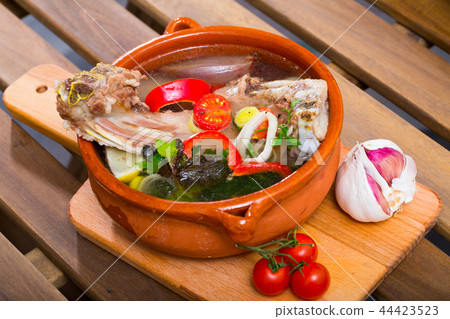 Lamb's soup cooked with vegetables, greens, onion and lemon, served in bowl Lamb's soup cooked with vegetables, greens, onion and lemon, served in bowl 44423523