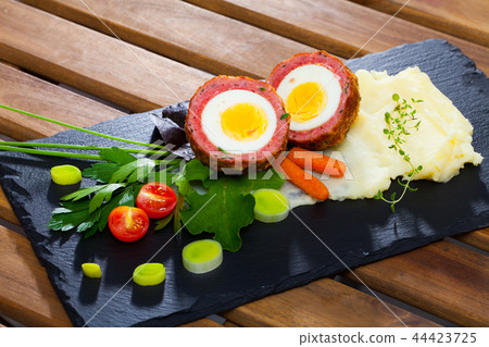 Scotch egg with pureed potatoes, carrots, tomatoes, greens Scotch egg with pureed potatoes, carrots, tomatoes, greens 44423725