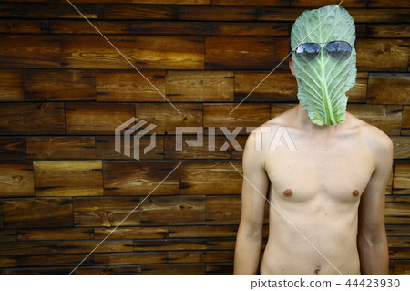 Young man with cabbage leaf mask Young man with cabbage leaf mask 44423930