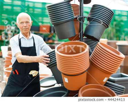 Man choosing pots for plants Man choosing pots for plants 44424413