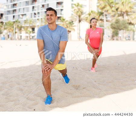 Couple training on beach Couple training on beach 44424430