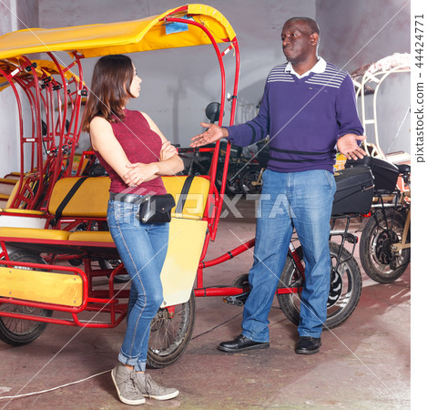 Indignant woman talking to rickshaw driver Indignant woman talking to rickshaw driver 44424771