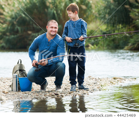 Man and little boy fishing 44425469