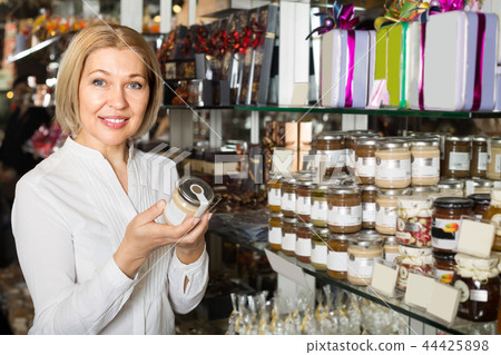 Consumer buying jar with honey. 44425898