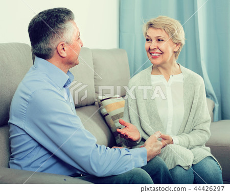 friendly mature married couple in house are warmly reconciled after quarrel 44426297