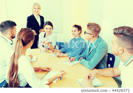 Female speaker giving presentation for students in lecture hall Female speaker giving presentation for students in lecture hall 44426371