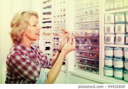 mature woman in sewing store. 44426800