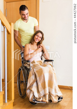 Worker brought woman in wheelchair 44427062