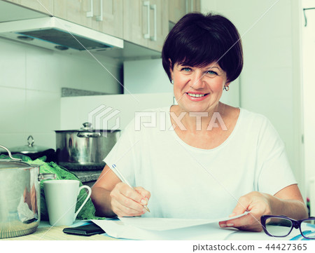 smiling woman bills 44427365