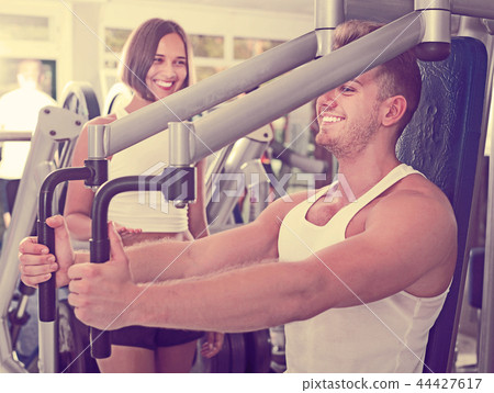 Female assisting man using fly machine Female assisting man using fly machine 44427617