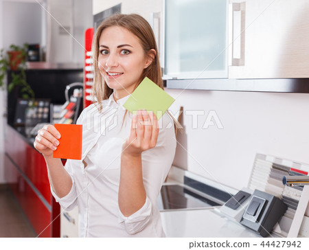 Girl choosing kitchen furniture materials Girl choosing kitchen furniture materials 44427942